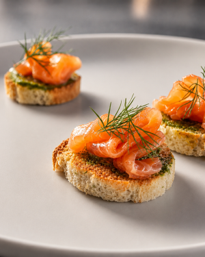 salmon gravlax crostini with kindzmari sauce